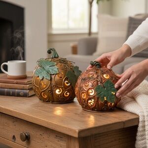 Decorative Metal Pumpkins with Leaf Accents and hold candles inside for a glow
